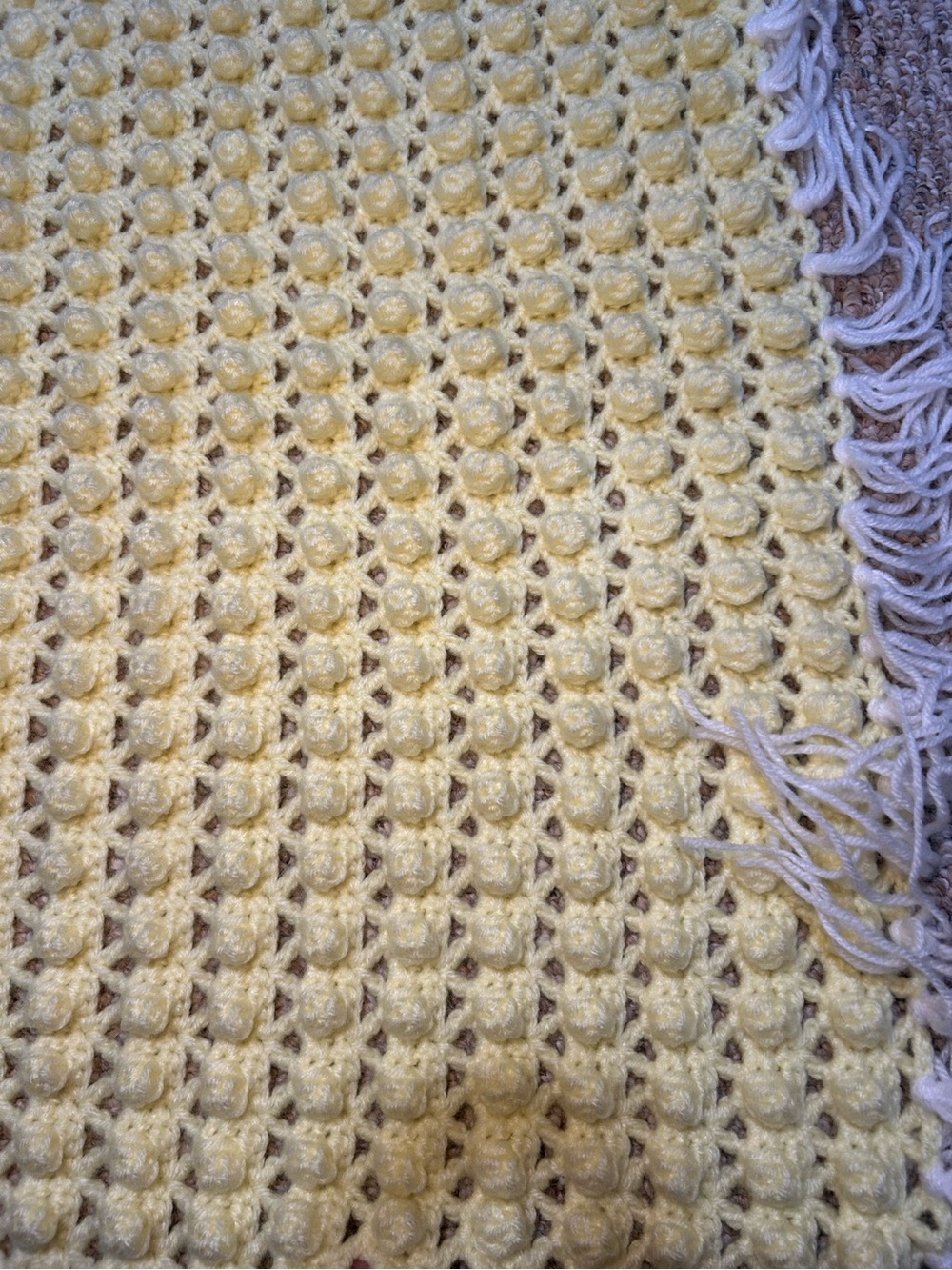 Light Yellow Crocheted Bubble Stitch Baby Blanket with white fringe